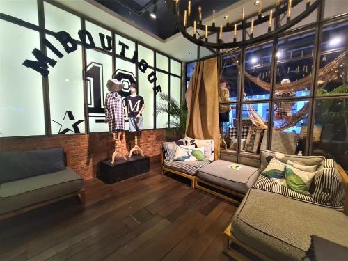 a living room with two couches and a window at M Boutique Hotel Station 18 - Ipoh in Ipoh
