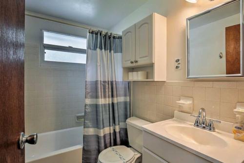 a bathroom with a sink and a toilet and a shower at Rita's Cottage by the Beach - Steps to Ocean! in Clearwater Beach
