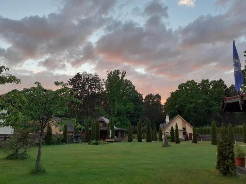 a large yard with a house and trees at Forest Edge Lodge in Rīga
