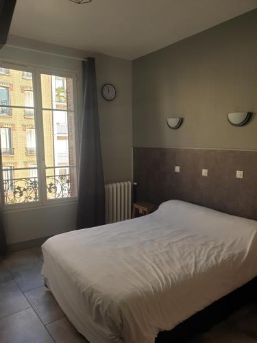 Katil atau katil-katil dalam bilik di Hôtel Belfort
