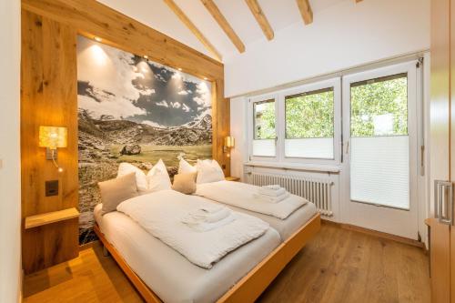two beds in a room with a large window at Ferienwohnung Haus Mia in Zermatt