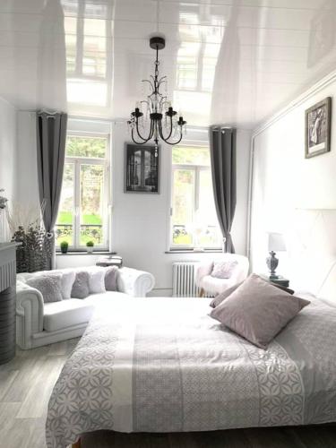 une chambre blanche avec un grand lit et deux canapés dans l'établissement La Felicità classement ****vue Cathédrale!, à Boulogne-sur-Mer