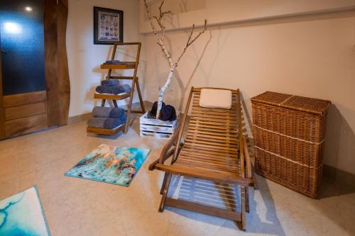 a living room with a rocking chair and a table at Villa Brallissima in Sveti Martin na Muri