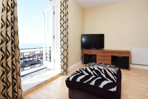 a living room with a large window and a television at Spacious 3 bedroom Beachfront property with amazing sea views! in Portsmouth