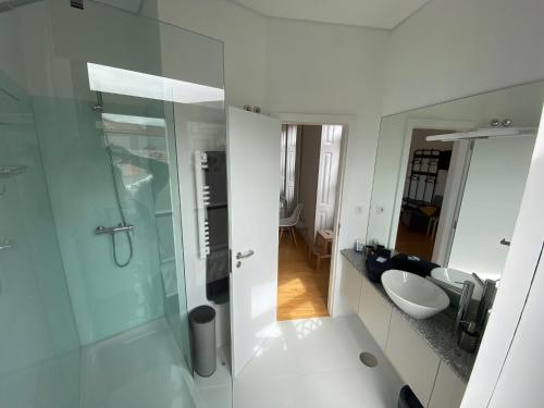 a bathroom with a glass shower and a sink at Porto.Leça - Studios and Apts (Apt D) in Leça da Palmeira