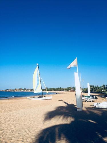 a group of sail boats on a beach at Appartement Luxueux En Résidence vu sur mer à 50 mètres de la plage in Sali Tapé