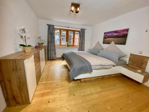 a bedroom with a bed and a wooden floor at Ferienwohnung Vorberg in Schönau am Königssee