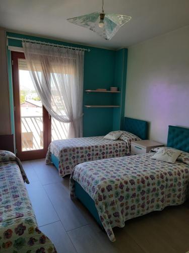 a hotel room with two beds and a window at casa Lorena in Frosinone