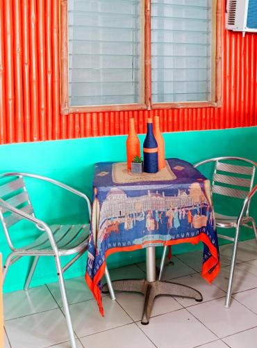a table in a room with two chairs and a table with at SmallFry's Beach Resort in Calatrava