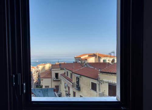 a window with a view of a city at Cefalu in Blu in Cefalù