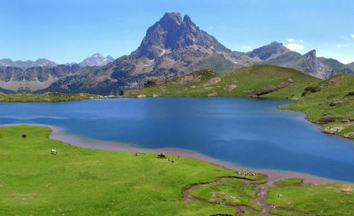 a large lake in the middle of a mountain at Appartement LARUNS 2 à 4 personnes in Laruns