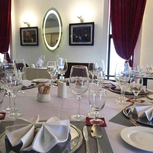 a table with wine glasses and napkins on it at Bei Boutique Hotel in Muar