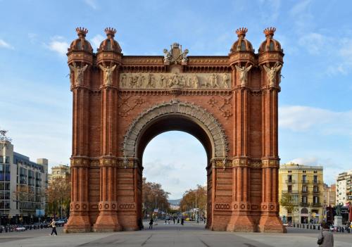 an arch in a city with people walking around at ibis Styles Barcelona Centre in Barcelona