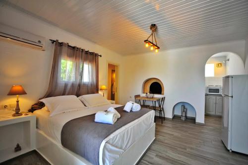 a bedroom with a large bed with towels on it at Anixis Studios Aliki Paros in Aliki