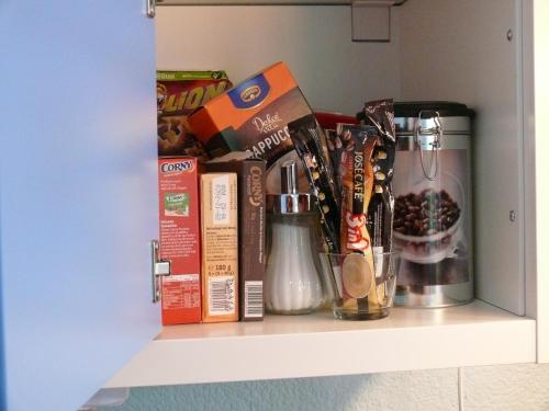 a shelf with books and other items on it at Gästezimmer in Aspach in Aspach