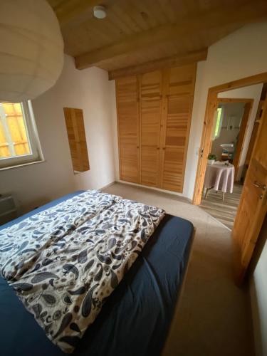 a bedroom with a bed with a blue comforter at Ferienhaus "Am Bergblick" Sebnitz in Sebnitz