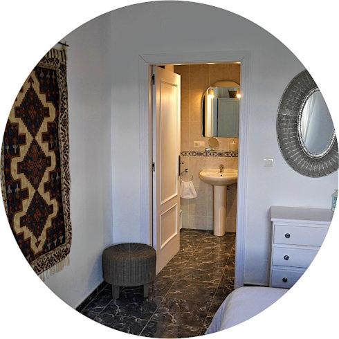 a bathroom with a toilet and a sink and a mirror at New Leaf Cortijo Apartment ,Moclin in Moclín