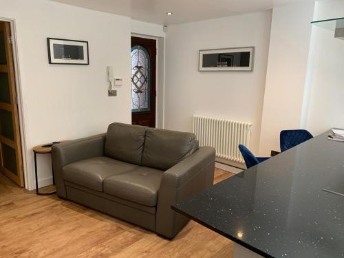 a living room with a couch and a table at Mitre Court Holiday Home in Plymouth