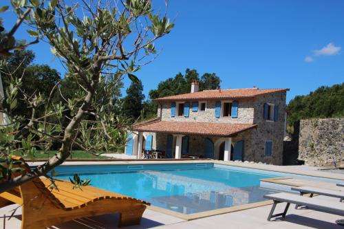 a villa with a swimming pool and a house at Villa Emma-Toscanaparadiso in Pomaia