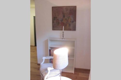 a living room with a chair and a fireplace at Hochwertiges Ferienhaus im romantischen Franken in Colmberg
