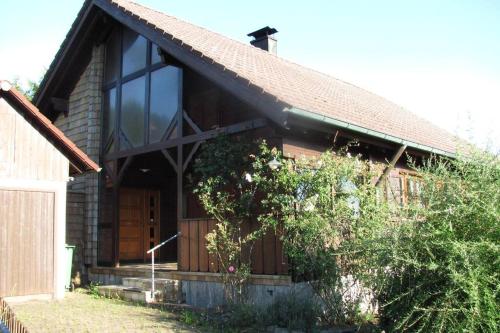 a house with a large window on the side of it at Hochwertiges Ferienhaus im romantischen Franken in Colmberg