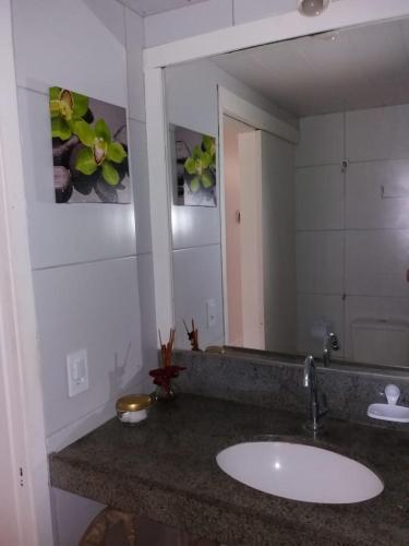 a bathroom with a sink and a large mirror at Eco Paradise Cumbuco 131 in Cumbuco