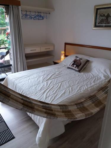 a bedroom with a bed with a wooden frame at Eco Paradise Cumbuco 131 in Cumbuco