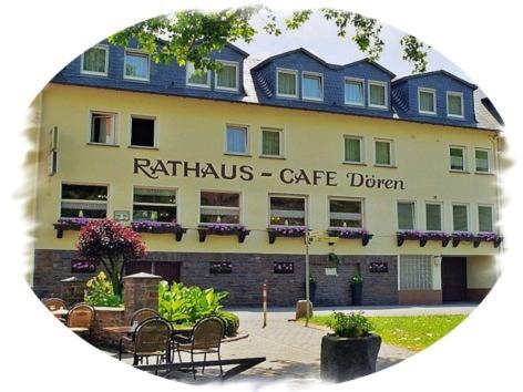 a building with a cafe in front of it at Pension Dören in Bruttig-Fankel