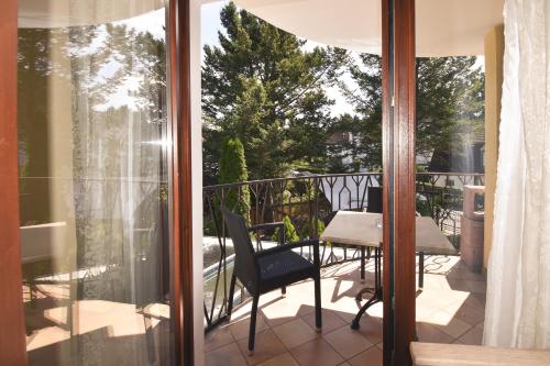 a balcony with a table and chairs on a patio at Boutique Hotel Sena in Berlin