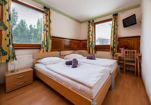 Unterwaltersdorf的住宿－Hotel Waitz -Self Check In，一间卧室设有两张床、一张桌子和窗户。