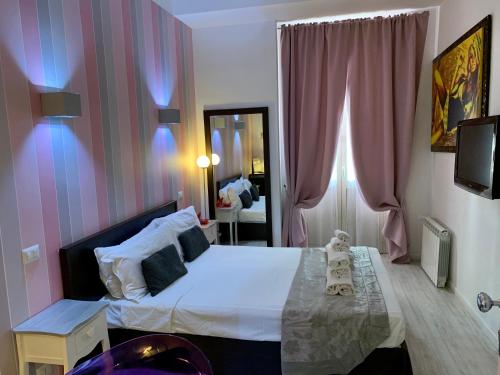 a bedroom with a bed and a mirror at Chroma Italy - Chroma Tessera in Rome
