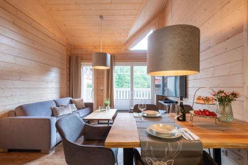 a living room with a blue couch and a table at Bergwaldsuites in Schierke