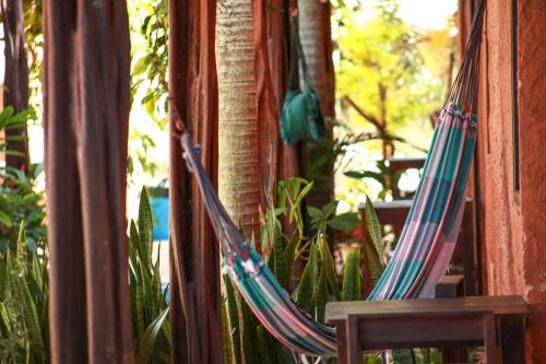 a couple of hammocks sitting on a porch at Pousada Corais do Sul in Pipa