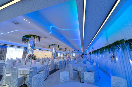 a banquet hall with white tables and chairs at Hotel Bavka in Leskovac