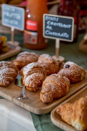 a bunch of pastries sitting on a table with signs at Locanda Bellevue in Pré-Saint-Didier