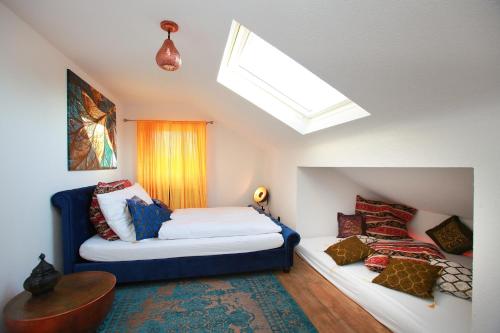 a attic bedroom with a bed and a window at 1001 Nacht Bodensee in Kressbronn am Bodensee