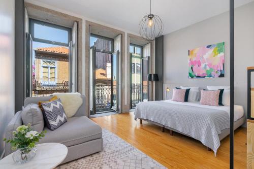 a bedroom with a bed and a couch at Canto De Luz - Luxury Maison in Porto