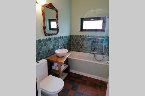 a bathroom with a tub and a toilet and a sink at Sprookjesachtig verblijven in Sunparks Oostduinkerke in Oostduinkerke