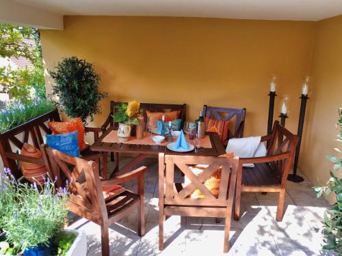 a wooden table and chairs in a patio at Mediterran-Skandinavisch - Outdoorwhirlpool ganzjährig in Burgthann
