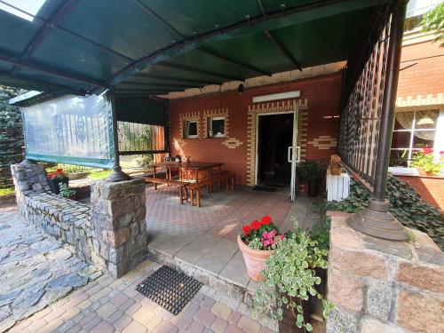 a screened in porch of a house with a patio at Pensjonat ,,Eden'' in Charbrowo