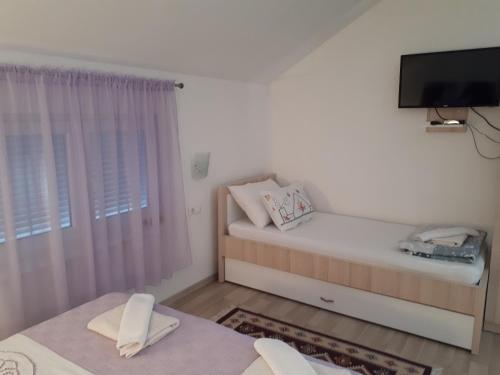Ένα ή περισσότερα κρεβάτια σε δωμάτιο στο Apartments City Paradise