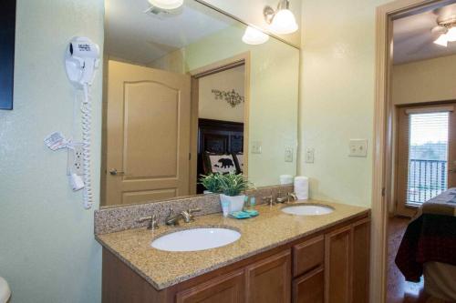 a bathroom with two sinks and a hair dryer at Mountain View Condo #3604 in Pigeon Forge