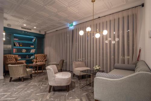 a waiting room with chairs and a couch and tables at Vivid Blue Serenity Resort in Sveti Stefan