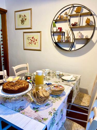 a dining room table with a cake and a mirror at BoTép ai Tigli in San Pellegrino Terme