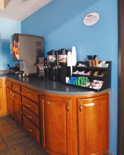 a coffee shop counter with a black counter top at Baymont by Wyndham Lafayette - Purdue University in Lafayette