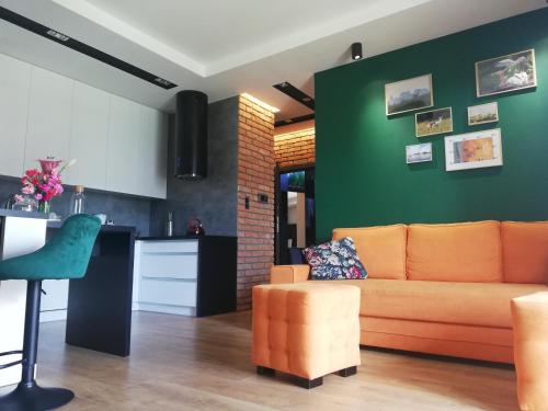 sala de estar con sofá y cocina en Apartament na Mazurach, en Ełk