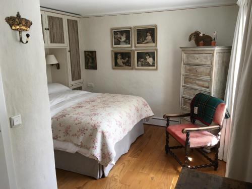 a bedroom with a bed and a chair and a dresser at Jaegerhaus at Schloss Bleichheim in Herbolzheim