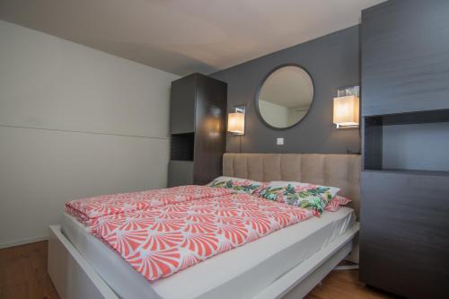 a bedroom with a large bed with a large mirror at House Erika in Šilo