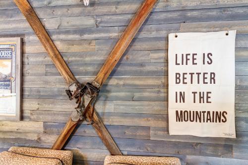 a sign hanging on a wall with two chairs at Fireside Inn & Hostel in Breckenridge