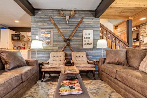 a living room with two couches and a large clock on the wall at Fireside Inn & Hostel in Breckenridge